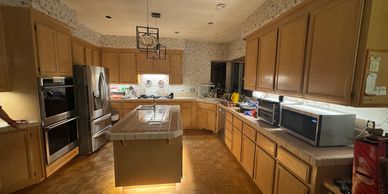 Spacious kitchen with wooden cabinets, island, and modern appliances.