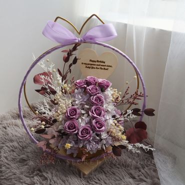 Elegant purple rose bouquet with a birthday message for a sister.