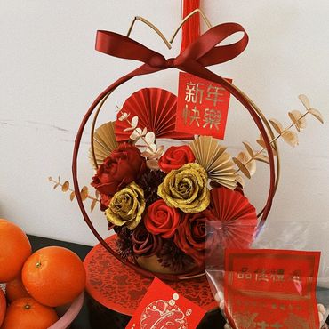 Chinese New Year decorations with traditional sweets and oranges on a table.