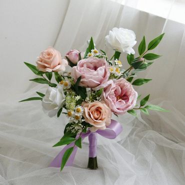 Elegant bouquet with pink and white roses tied with a lavender ribbon.