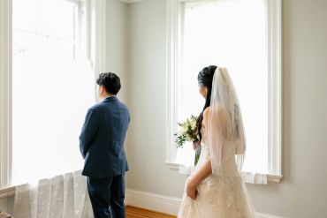 Bride and groom in a bright room before the ceremony.
