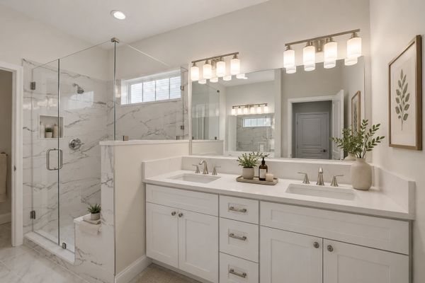 Modern bathroom with dual sinks, glass shower, and neutral tones.