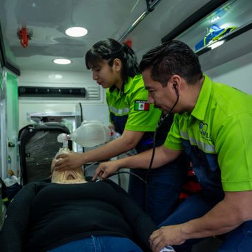 Two paramedics providing emergency care inside an ambulance.