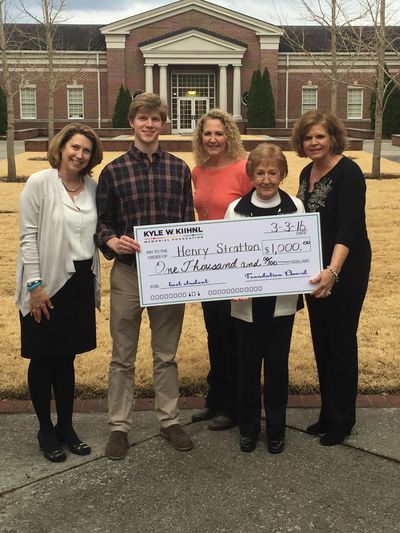 Photo of a previous scholarship recipient receiving his check