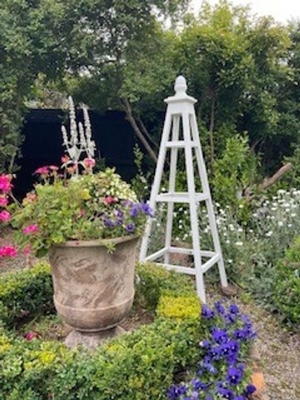 White garden obelisk with horizontal rails