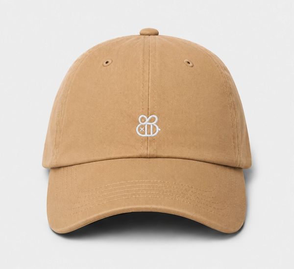 Tan baseball cap with a small white bee logo on the front.