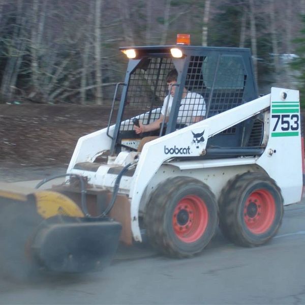 Cleaning with the bobcat skidsteer brush