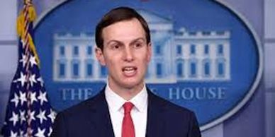 Man speaking at White House press briefing with American flag.