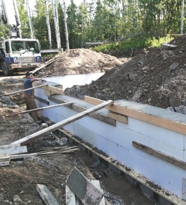 Construction worker by concrete foundation

