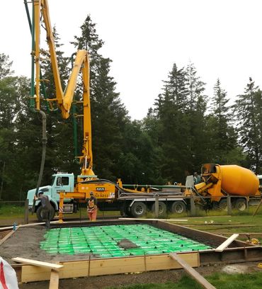 Pumping concrete onto foundation grid

