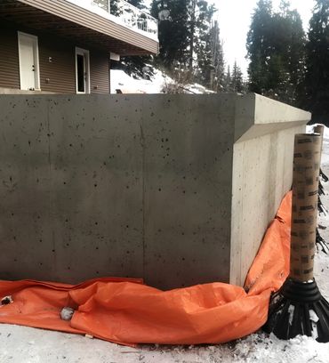 Concrete wall with orange construction tarp
