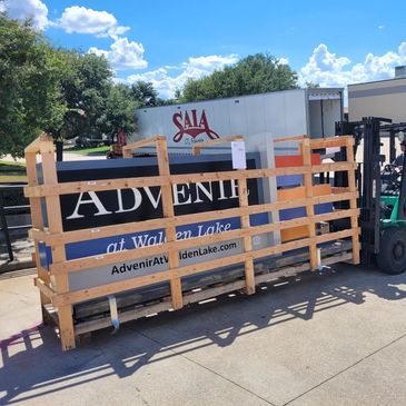 A monument sign being delivered with a fork lift