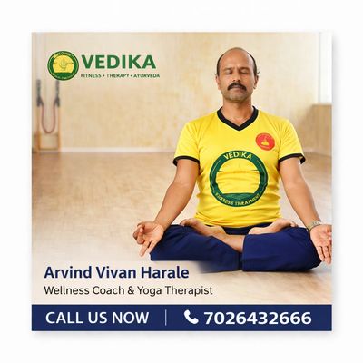 Wellness coach Arvind Vivan Harale practicing yoga in yellow Vedika shirt.