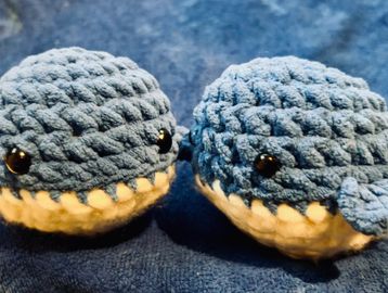 Two crocheted blue whales