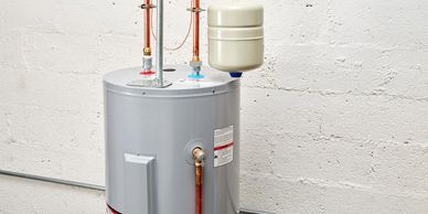 gas water heater showing pressure relief tank on top side of heater.