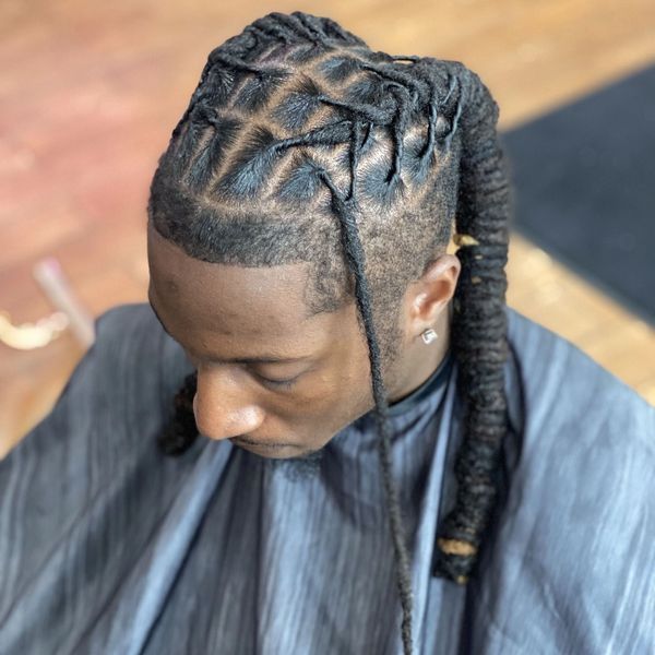 Intricately braided hairstyle on a man.