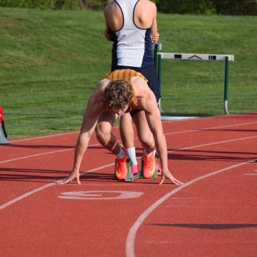 Athlete in starting position on a track.
