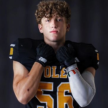 Young football player in black uniform.