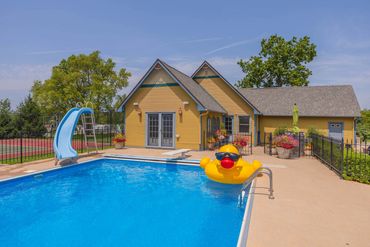 classy design of swimming pool along with a small house