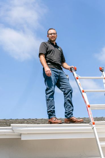 An inspector is standing on the house roof 