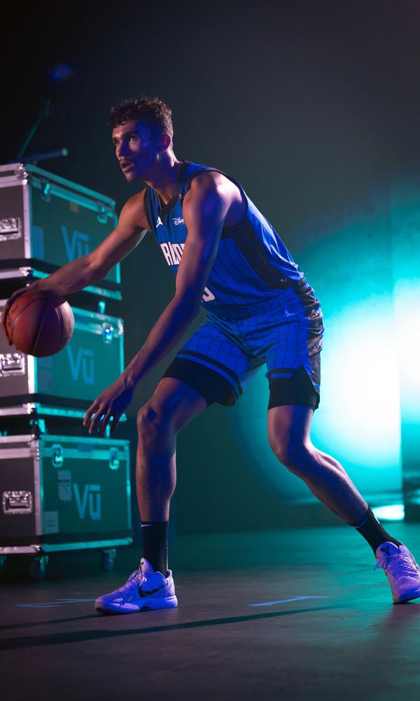 Basketball player dribbling the ball in action.