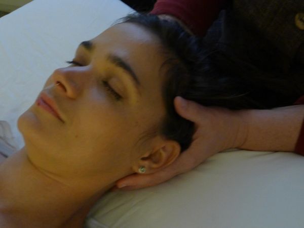 Therapist hands providing gentle craniosacral therapy promoting balance at Wholly Spirit Hands Sugar