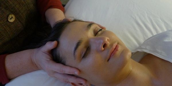 Woman receiving craniosacral therapy promoting balance at Wholly Spirit Hands Sugar Land.