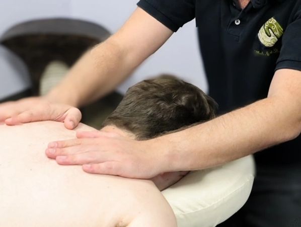 Massage therapist performing manual lymphatic drainage therapy at Wholly Spirit Hands.