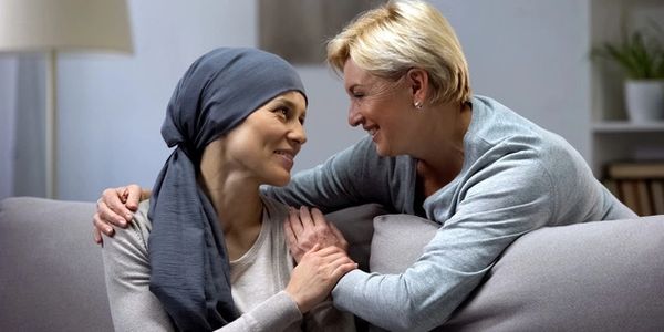 Massage therapist comforting oncology massage client in Sugar Land, TX.