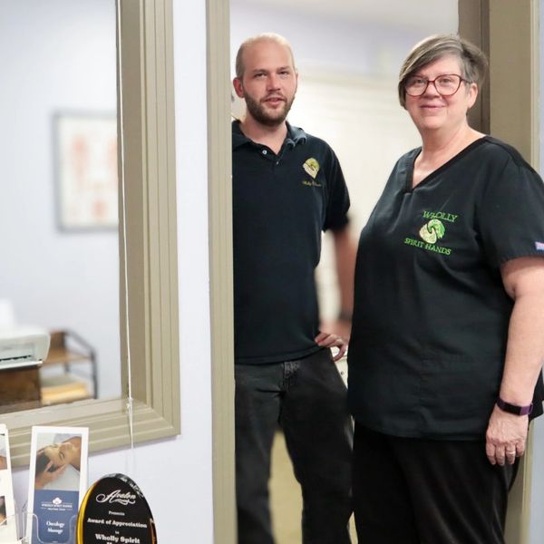 Massage therapy team providing manual lymphatic drainage therapy at Wholly Spirit Hands Sugar Land.