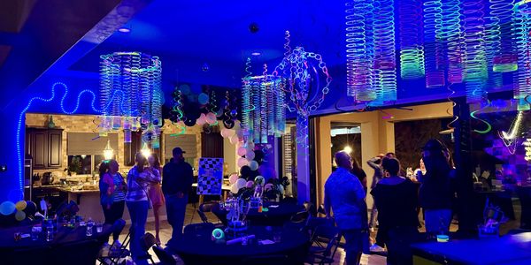 80’s glow party with custom decorations, tables and chairs 