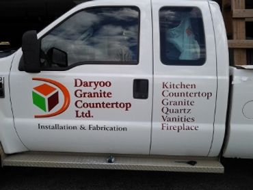 Truck with advertising for granite countertop company.