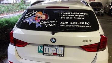 Car advertisement for Little Dolphins Children's Place daycare.