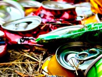 Colorful crushed soda cans on the ground.