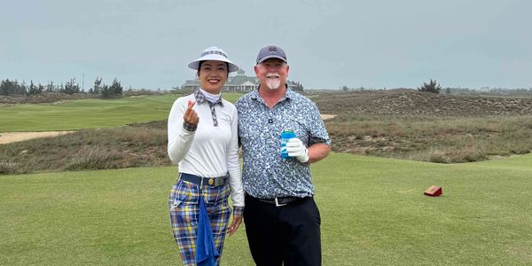 Chris Rideout standing with his caddy at Hoiana Shores golf course in Vietnam