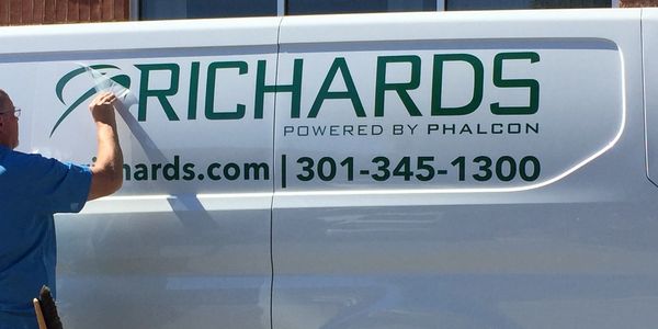 A truck with a vehicle wrap on the outside.