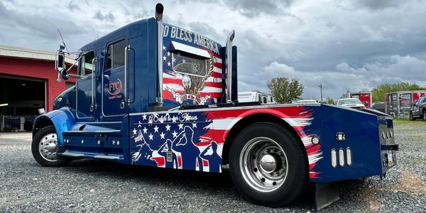 Truck featuring a full vehicle wrap showcasing custom branding and graphics.