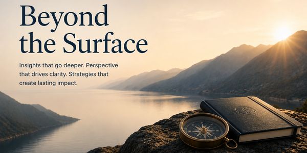 Compass and journal overlooking serene lake and mountains.