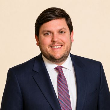 Smiling man in a suit and tie.