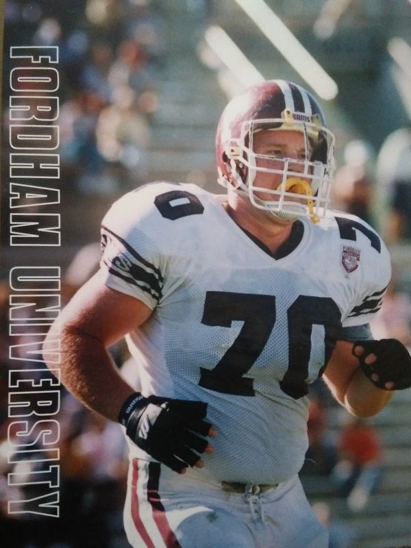 Fordham University football player in uniform with helmet and mouthguard.