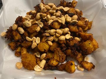 diced plantains mixed with ginger sauce  before frying. Served with or without peanuts  