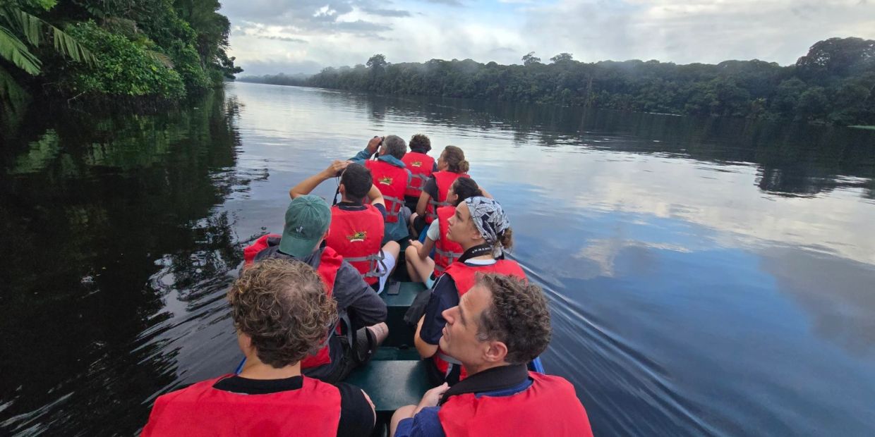 Guests exploring Tortuguero Lagoon on a guided canoe tour