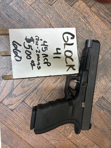 Glock 41 .45 ACP pistol displayed with a price tag on wooden surface.