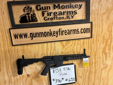 Gun Monkey Firearms display with a PSA 5.56 pistol for sale.