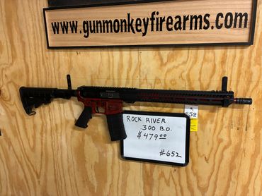 A Rock River firearm displayed with price and website sign.