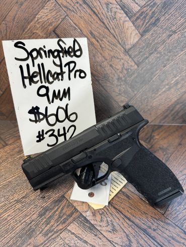 Springfield Hellcat Pro 9mm pistol displayed with price tags.