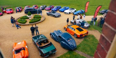 Luxury and sports cars gathered in an outdoor area.