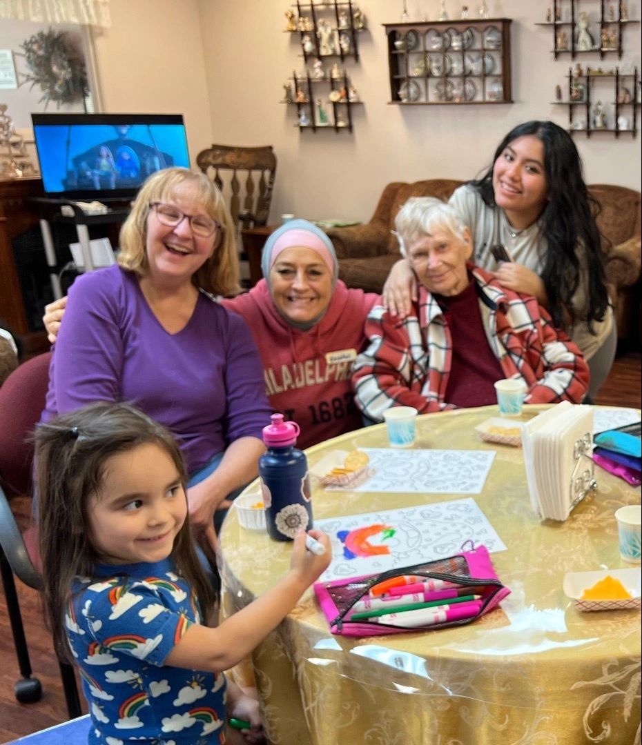 Seniors a child and a caregiver enjoy time with art at Gentog Intergenerational Adult Day Center