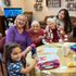 Seniors a child and a caregiver enjoy time with art at Gentog Intergenerational Adult Day Center