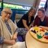 Seniors and a caregiver enjoy time with a game at Gentog Intergenerational Adult Day Center